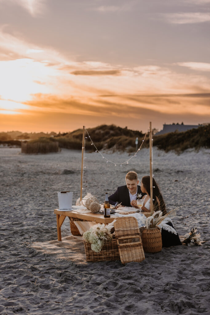 Romantic sunset Couples picnic on a wedding day at a beach in Rhode Island by EZ Elopements