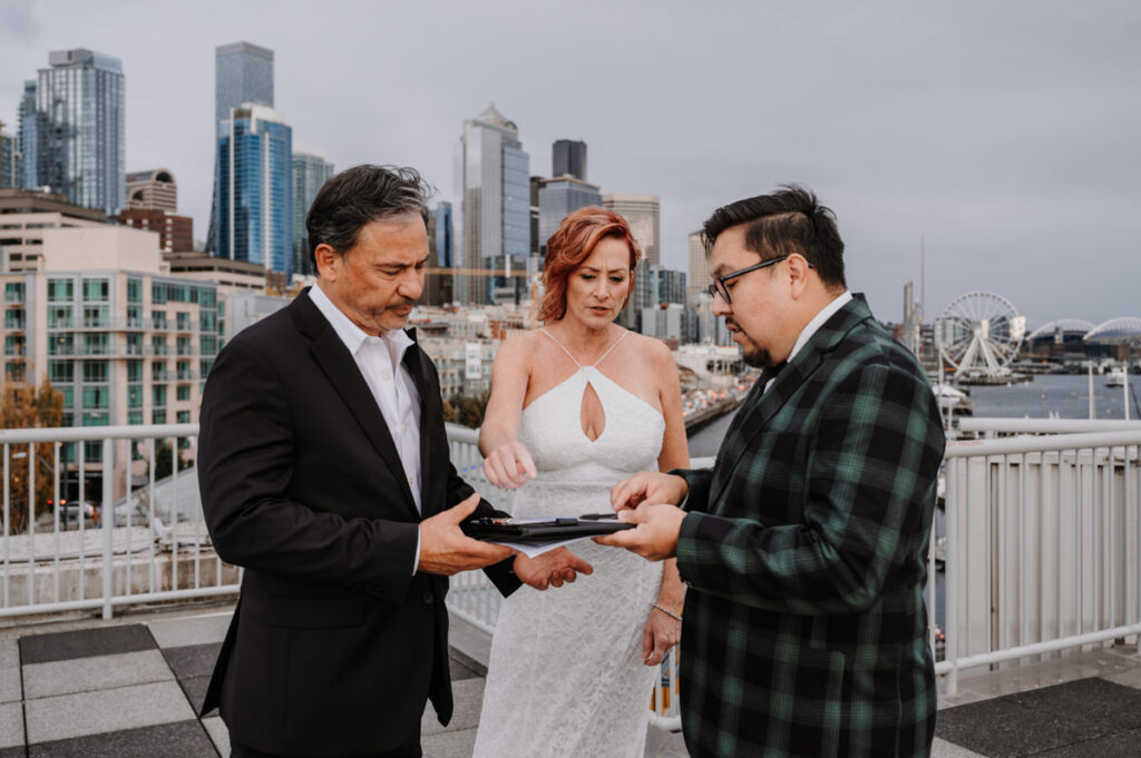 Couple signing their marriage license per legal requirements in Seattle WA by EZ Elopements officiant