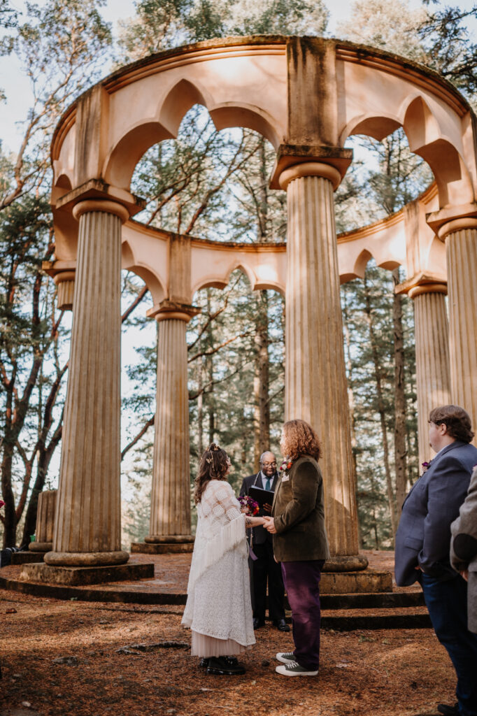 a couple eloping in a forest mausoleum