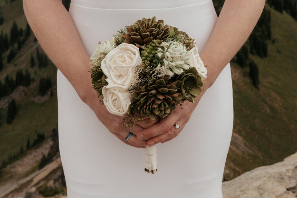 smaller classic round bouquet made with cream and sage green sola wood flowers