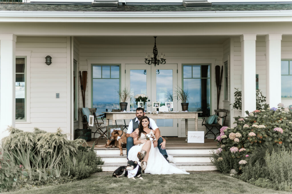 a couple in nice clothes seated in front of a lovely home decorated for a wedding. 