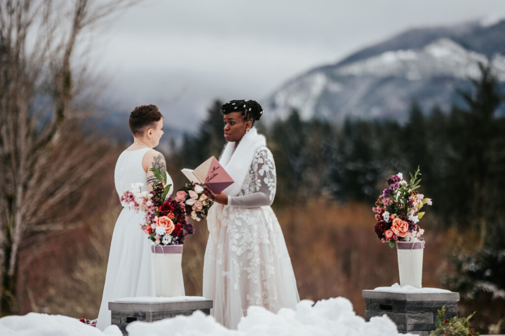 Couple getting married in the snowy mountains of Mt Rainier cabin in winter by EZ Elopements