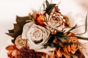 Overview of a sola wood bouquet made with orange, ivory, and natural wood flowers.