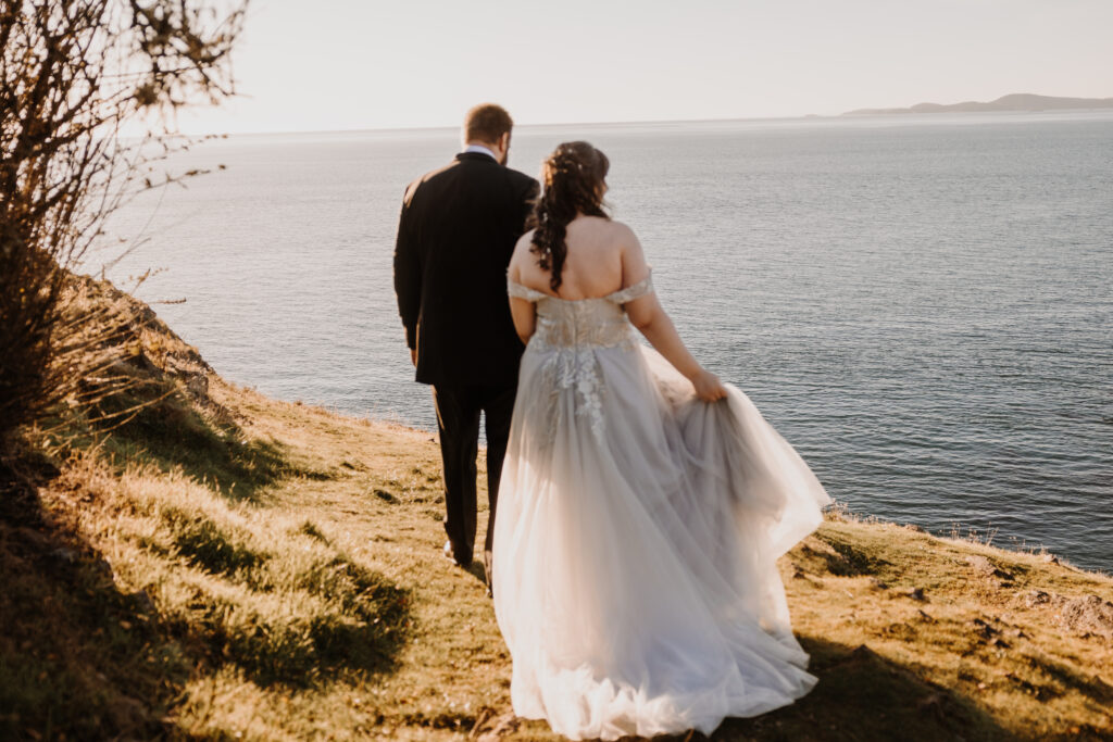Bride and Groom walking along the coast before their elopement.